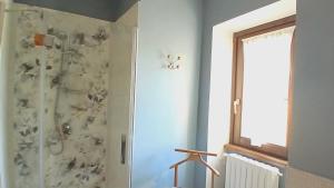 a bathroom with a shower with a shower curtain at Il Bagolaro - Alloggio turistico in Tuscania