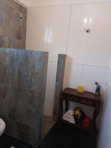 a bathroom with a shower and a sink and a toilet at Casa Club Descanso in General Rodríguez