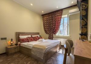 a bedroom with a bed and a window at Suvenir Hotel in Baku