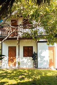 a house with two garage doors in a yard at Casa Maracanã in Barreirinhas