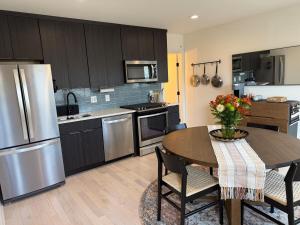 a kitchen with a table with chairs and a refrigerator at Cozy Old Town Apartment in Alexandria