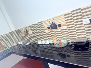 a counter top with a pot and shoes on it at J Rest in in Trincomalee +19 photos