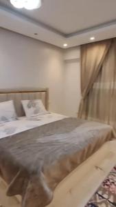 a bedroom with a bed and a window at إسراء المهندسين in Cairo
