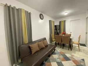 a living room with a couch and a table at Eevee's Homes B14 L19 Bacolod in Bacolod