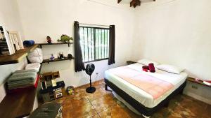 a bedroom with a bed and a window at Casa Escondida in Cahuita