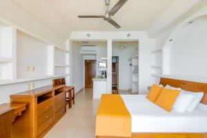 a living room with a bed and a kitchen at Punta Mita Litibu Beachfront Studios Mar-3 in Punta Mita