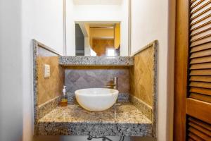 a bathroom with a white bowl sink on a counter at Punta Mita Litibu Beachfront Studios Mar-3 in Punta Mita +27 photos