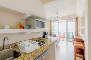a kitchen with a sink and a counter top at Punta Mita Litibu Beachfront Studios Mar-3 in Punta Mita