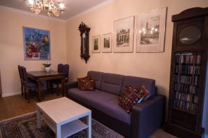 a living room with a couch and a table at Apartament Mundus in Sopot
