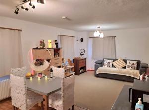 a living room with a bed and a table and chairs at Vacances en tout tranquillité à Vercorin in Vercorin