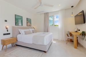 a bedroom with a bed and a desk and a television at Luxury Villa Rika Corfu- 5 bedrooms with Pool in Gouvia