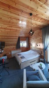 um quarto com uma cama grande num chalé de madeira em VIP Durmitor em Žabljak