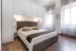 1 dormitorio con 1 cama grande en una habitación blanca en San Jacopino - Flo Apartments, en Florencia