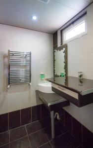 a bathroom with a sink and a mirror at Tatev Apartments in Yerevan +43 photos