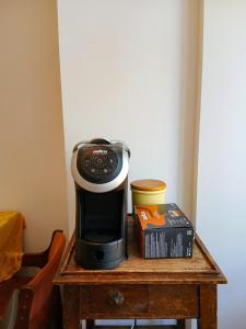 a coffee maker on top of a wooden table at Sanremo Apartments - Orchidea in Sanremo