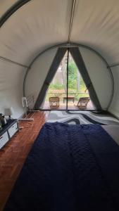 a room with a tent with a bed in it at Tepian Pinus Glamping in Palayangan +22 photos