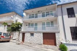 an apartment building with a car parked in front of it at Apartment Anne in Crikvenica