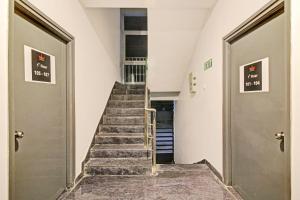 a staircase in a building with two doors and a stair case at Hotel O SS Skyline in Hyderabad