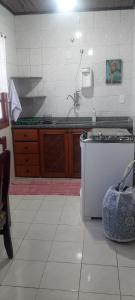 a kitchen with a stove and a counter top at Charmosa Casa de Madeira a 700 metros da praia in Rio das Ostras