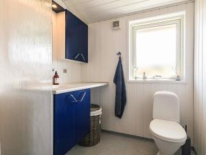 a small bathroom with a toilet and a window at 6 person holiday home in Hjørring in Hjørring