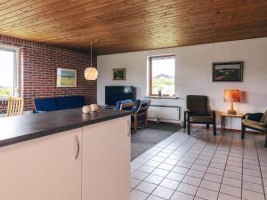a kitchen and living room with a couch and chairs at 7 person holiday home in Frøstrup in Frøstrup +20 photos