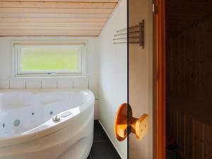 a white tub in a bathroom with a window at Luxury Retreat with Spa - By Traum Ferienwohnungen in Dannemare +33 photos