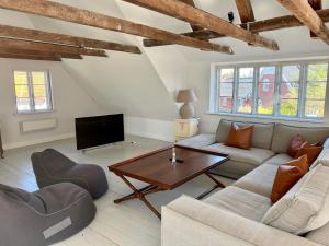 a living room with a couch and a table at 6 person holiday home in Skagen-By Traum in Skagen +39 photos