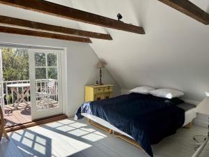 a bedroom with a bed and a balcony at 6 person holiday home in Skagen-By Traum in Skagen
