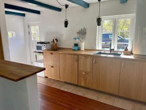 a kitchen with wooden cabinets and a sink at 6 person holiday home in Skagen-By Traum in Skagen
