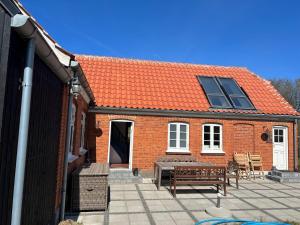 a brick house with a table and a roof at 6 person holiday home in Skagen-By Traum in Skagen +30 photos