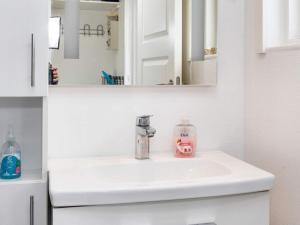 a bathroom sink with a bottle of soap on it at 6 person holiday home in Hadsund-By Traum in Hadsund +18 photos