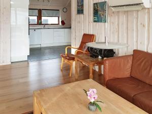 a living room with a couch and a table at 6 person holiday home in Sydals-By Traum in Neder Lysabild