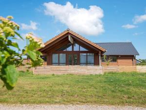a home with a wooden house on a field at 6 person holiday home in Sydals-By Traum in Neder Lysabild