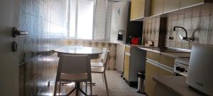 a small kitchen with a table and a chair in it at CarriCHe 2 in Lisbon