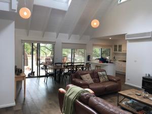 a living room with a couch and a table at Beachside Phillip Island in Cowes