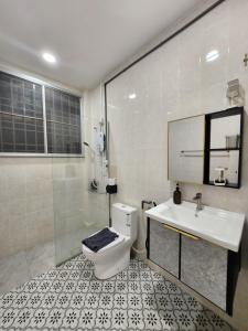 a bathroom with a toilet and a sink and a shower at Ipoh pasir puteh vibrant home 4br 15 pax in Ipoh +49 photos
