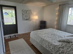a bedroom with a bed and a window at Small cottage in Toholampi