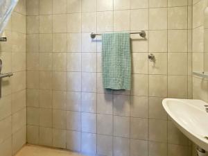 a bathroom with a shower with a green towel at 4 person holiday home in VETLANDA-By Traum in Vetlanda