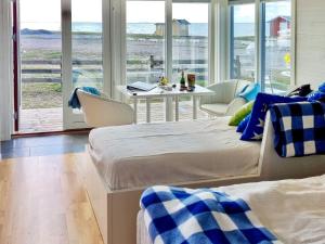 two beds in a room with a view of the ocean at 3 person holiday home in LÖTTORP-By Traum in Löttorp