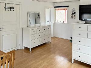 a living room with a white dresser and a television at 4 person holiday home in Södertälje-By Traum in Södertälje