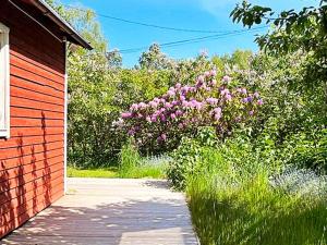 a garden with pink flowers next to a building at 4 person holiday home in Södertälje-By Traum in Södertälje