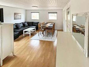 a living room with a black couch and a table at 4 person holiday home in Södertälje-By Traum in Södertälje