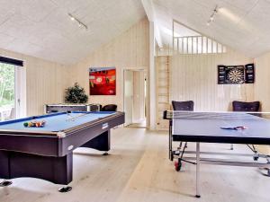 a billiard room with a pool table and chairs at 20 person holiday home in Hasselberg in Kappeln