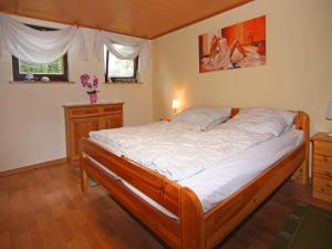 a bedroom with a large bed with white sheets at Ferienhaus, Dolgen am See in Klein Sprenz