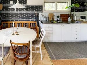 a kitchen with a white table and some chairs at 5 person holiday home in STRÄNGNÄS-By Traum in Strängnäs +13 photos
