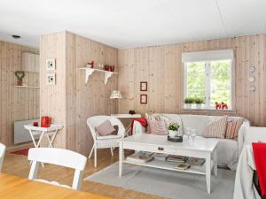 a living room with a couch and a table at 8 person holiday home in SKÅNES FAGERHULT-By Traum in Skånes Fagerhult