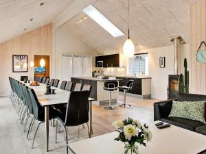 a living room and kitchen with a table and chairs at 24 person holiday home in Hasselberg in Kappeln