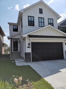 a white house with a two car garage at Affordable Cozy Bedroom Close to YYC Airport in Calgary