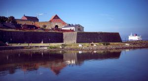 a castle sitting next to a large body of water at Home Hotel Fregatten in Varberg