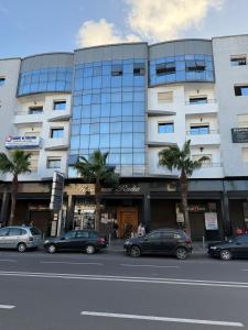 a large building with cars parked in front of it at The heart of El Jadida, centre ville in El Jadida